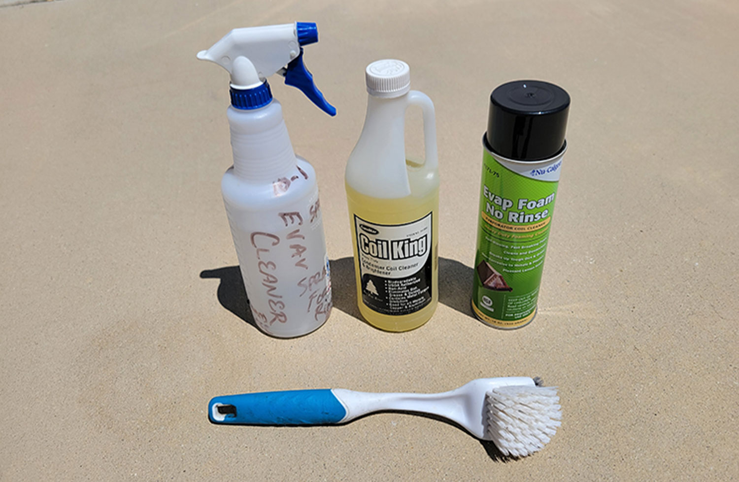 cleaning tools on disply including a container of Nu-Calgon evaporator foam, Coil King Condenser Coil cleaner and a dishwashing wand