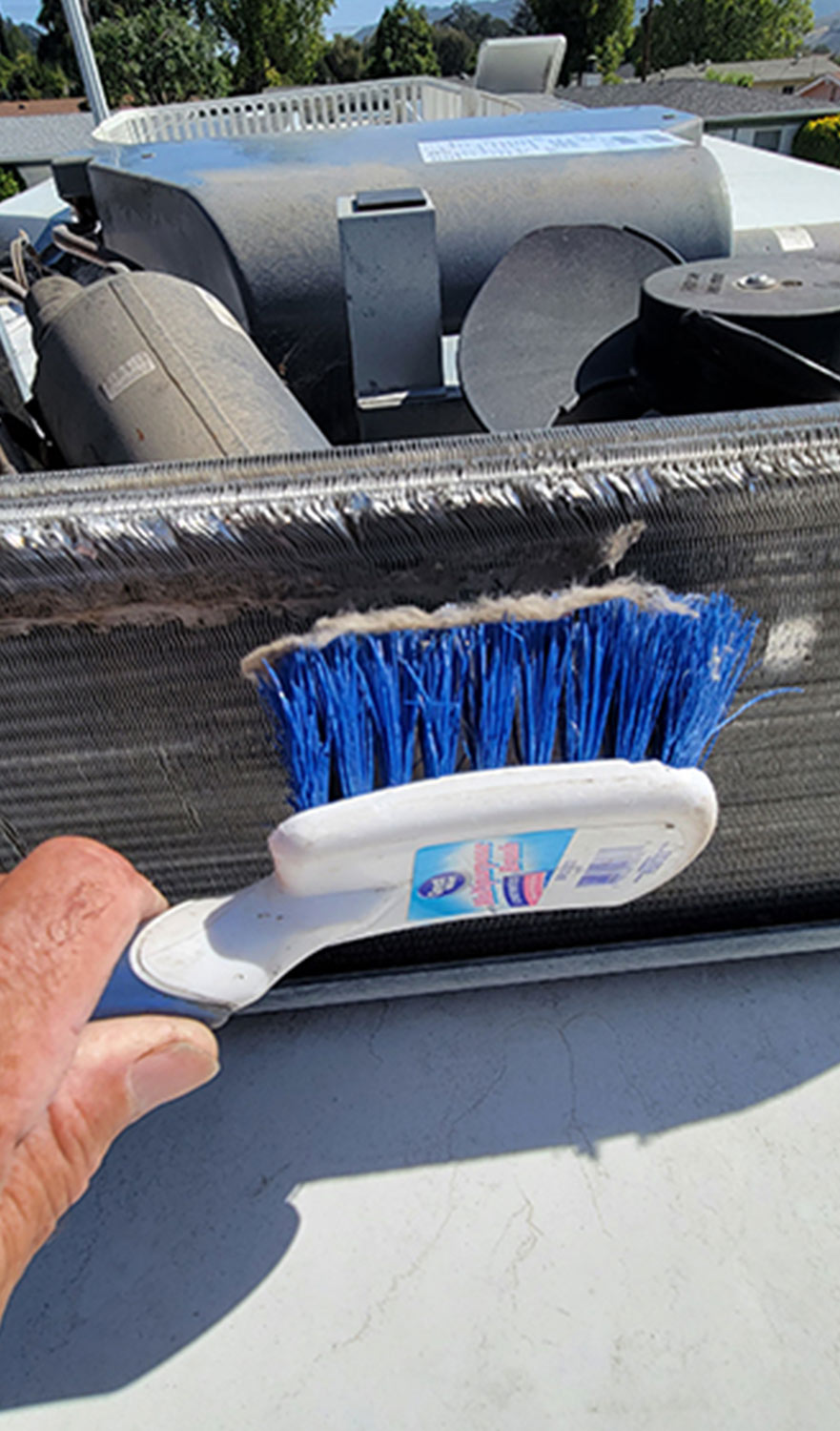 a basic utility brush is used to lightly remove debris from the condenser