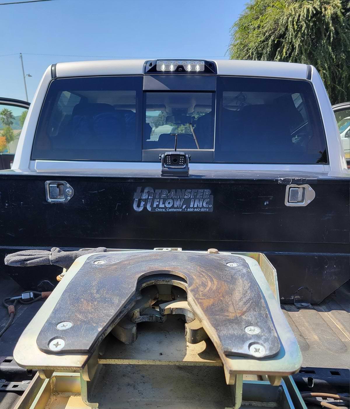 back view of a heavy duty pickup truck with the DoHonest camera mounted on the metal toolbox in the very front of the pickup bed