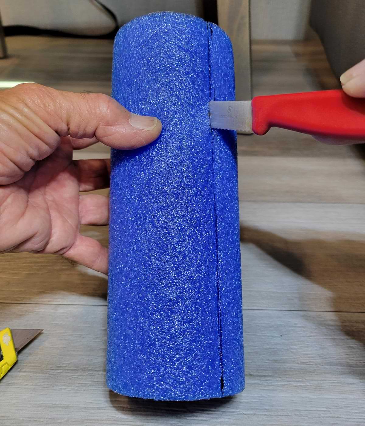 a bright blue swim noodle piece, cut to the proper length is then cut down the middle to make a slit opening