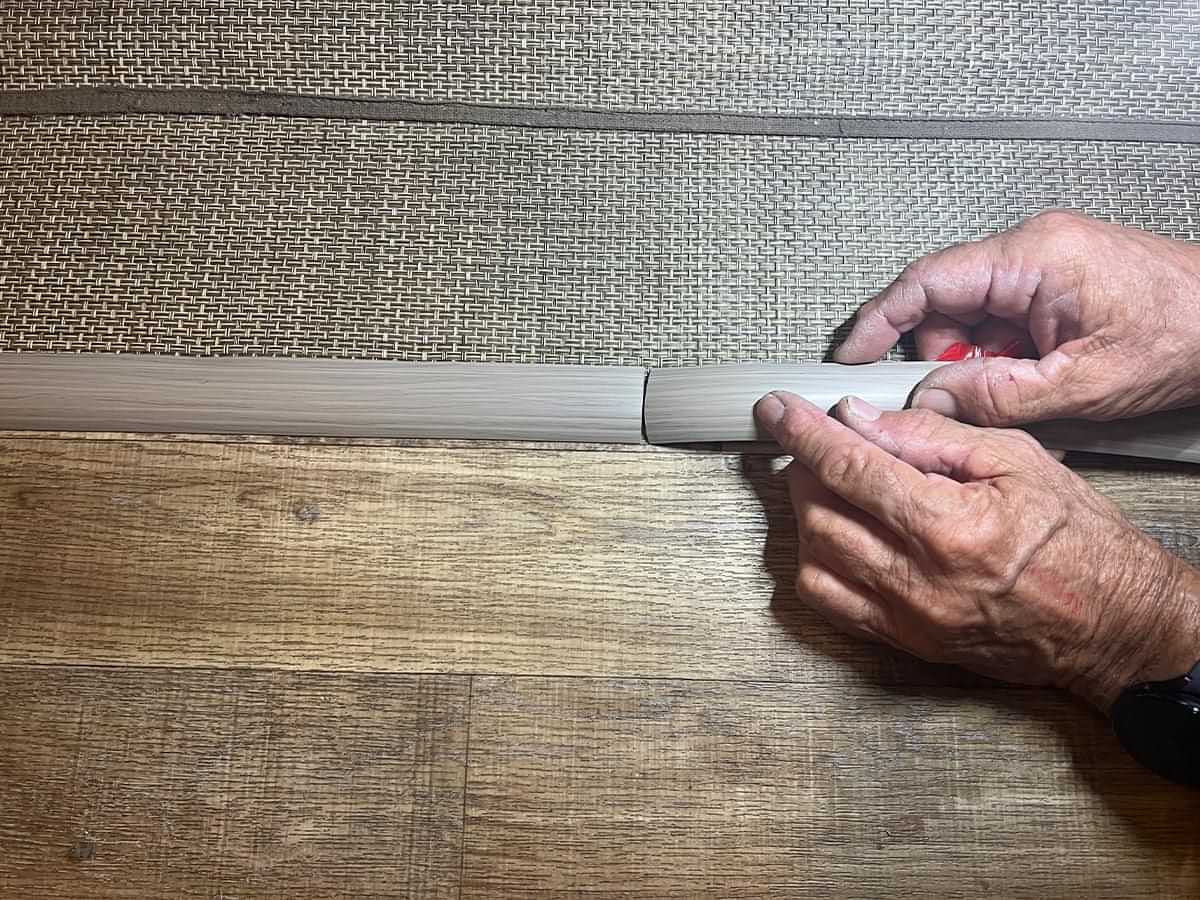 a second strip of transition material is applied to the woven vunyl edge directly after the first strip