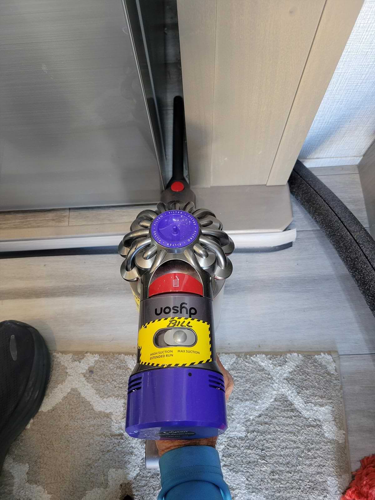 a Dyson V7 is used to clean the gap to the side of the RV refrigerator but the extension tube is not long enough to reach the back
