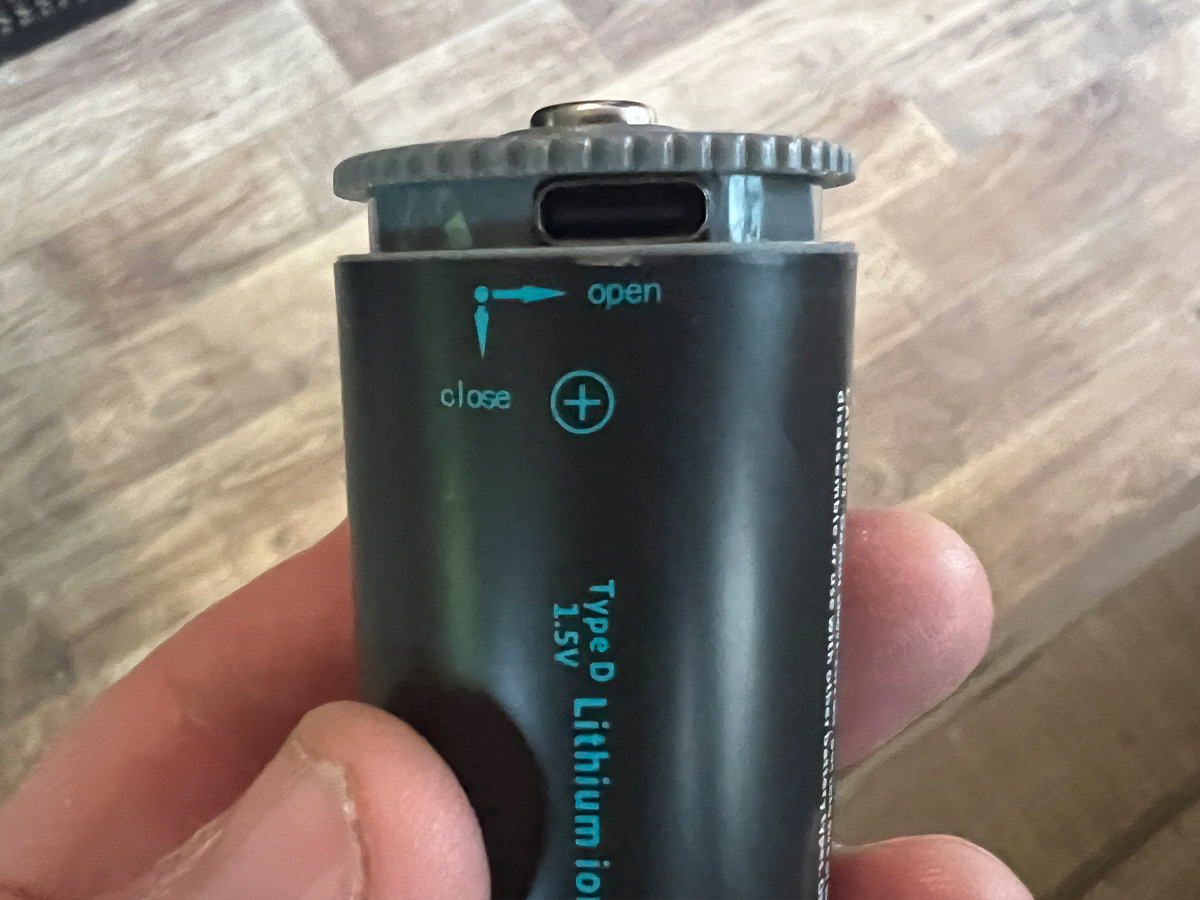 close view of a type D Paleblue battery with the twist top open to expose the USB-C charging port