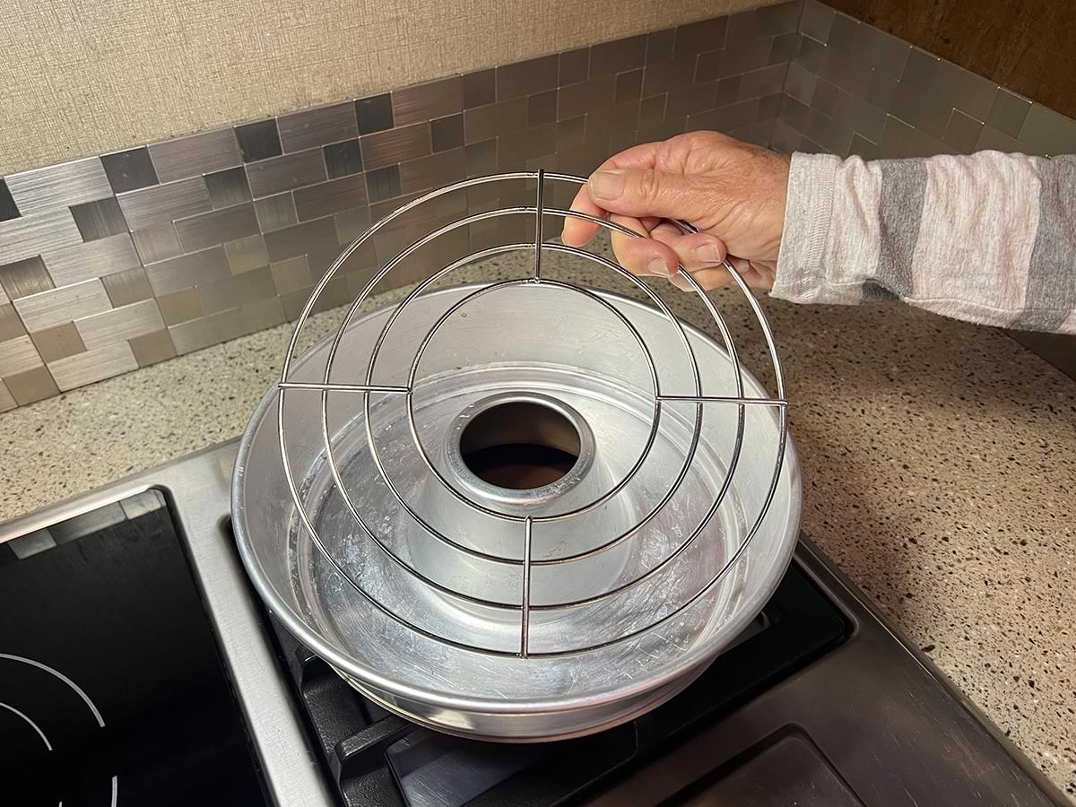 a circular oven rack is placed in the Omnia bowl on the cooktop