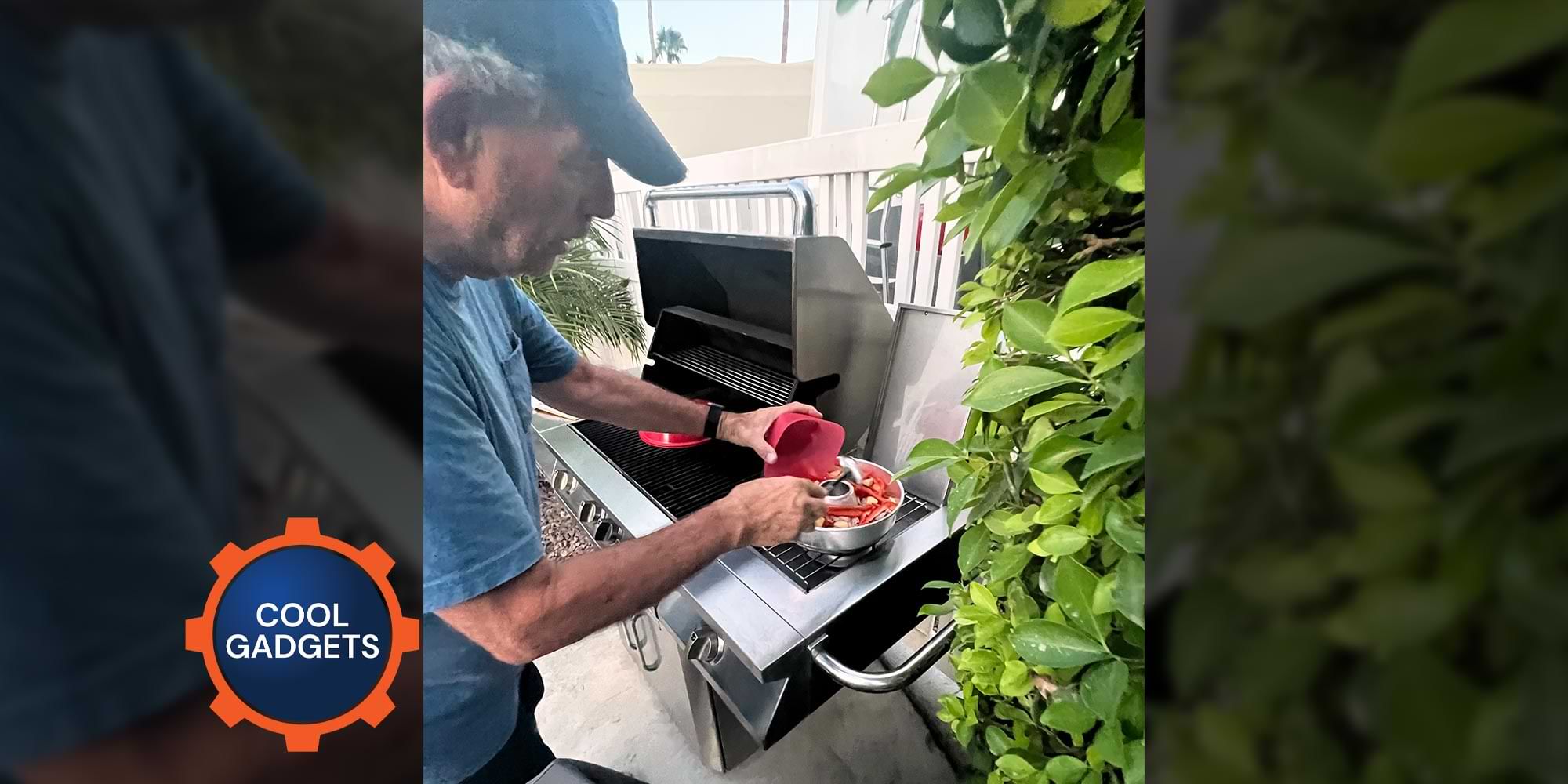 a man pours vegetables into a cooking container that sits on a side grate of a large grill