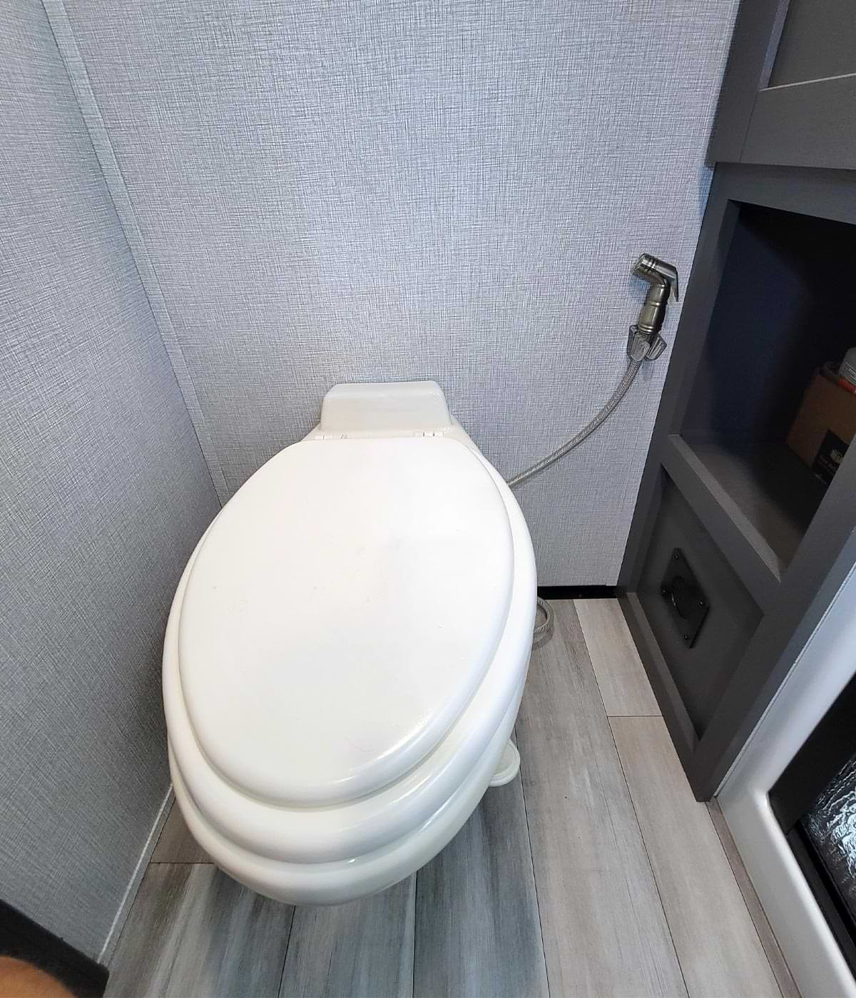 view of an RV toilet with the seat down