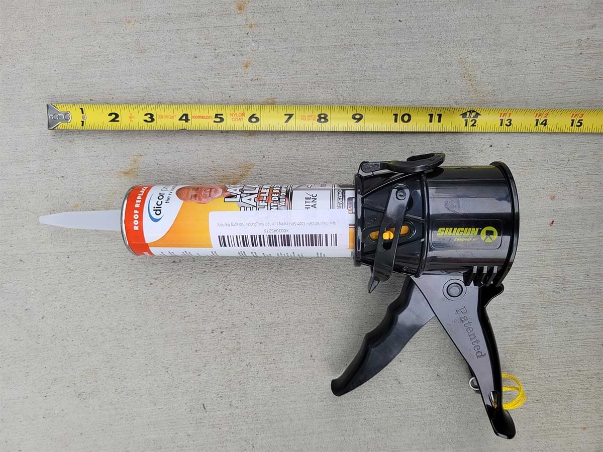 close top view of the Siligun measuring 13 inches beside an extended tape measure