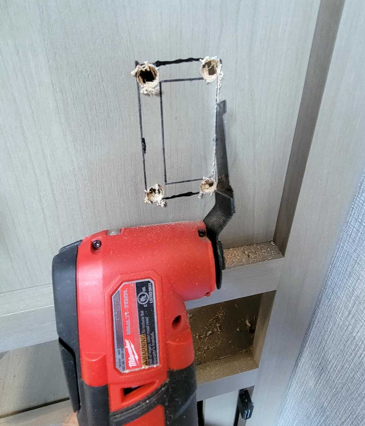 an oscillating-tool blade is used to cut the outlet opening