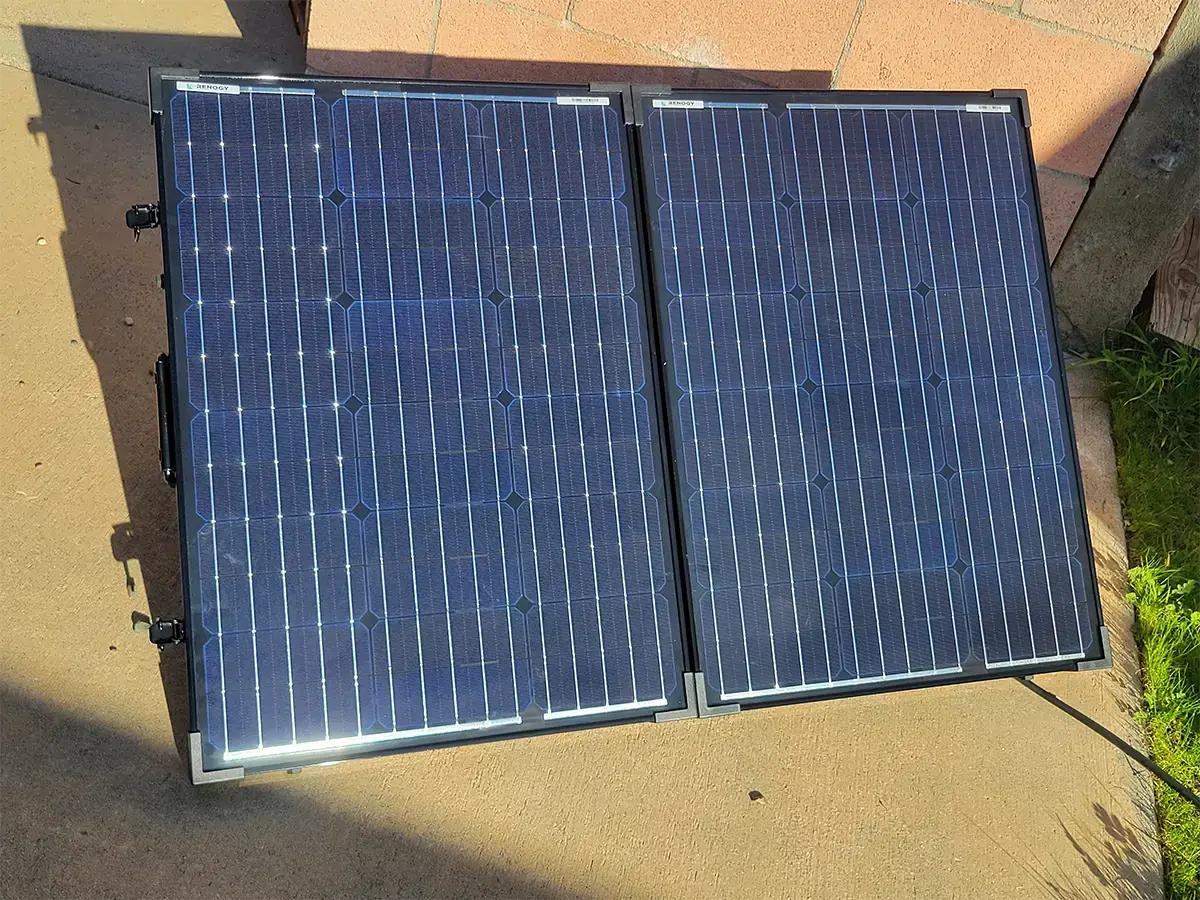 close view of the Renogy solar panel placed on the ground facing the sun
