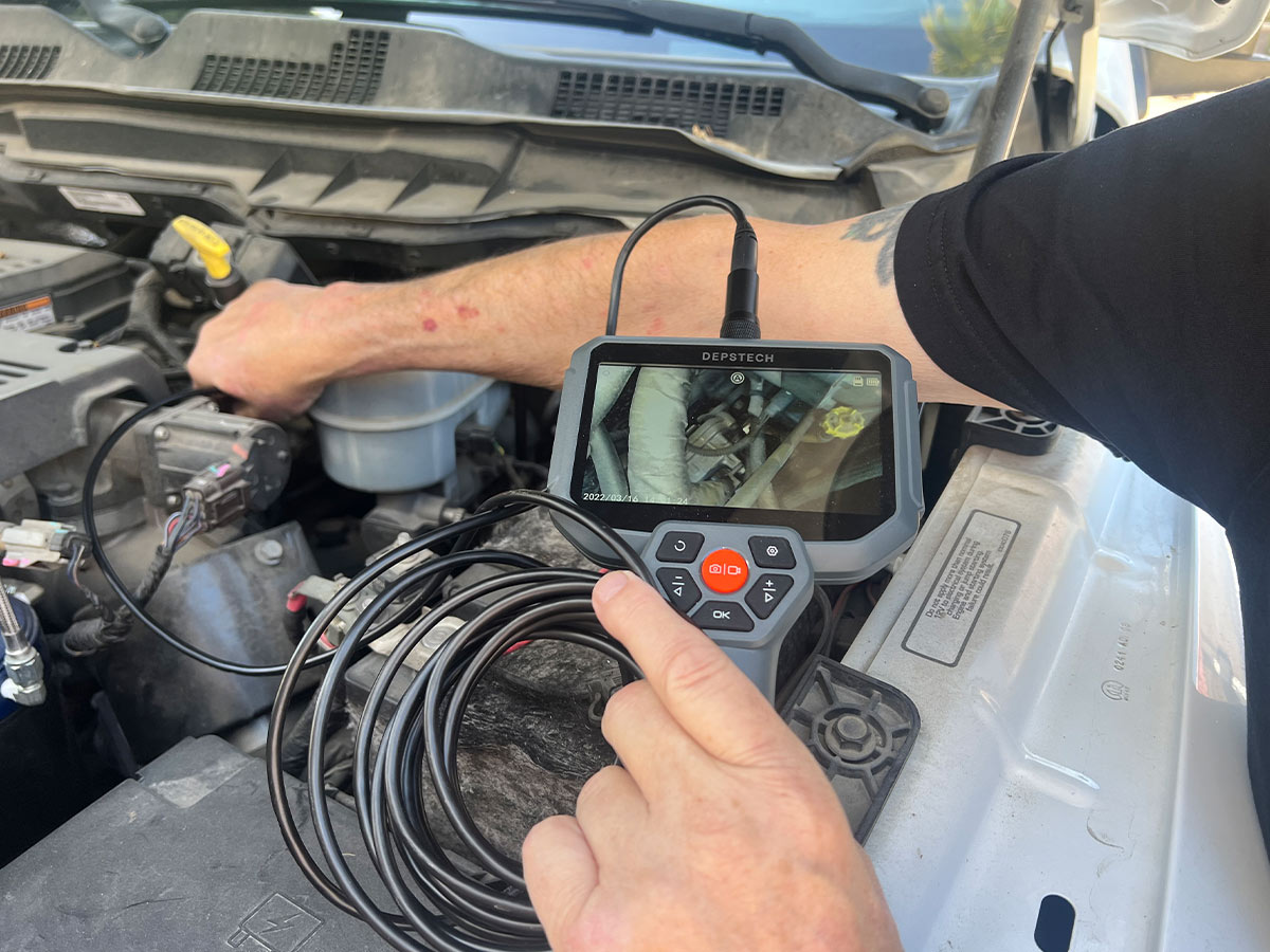 the Depstech DS590 endoscope is used to look within the engine of a truck