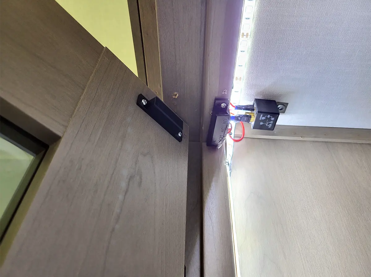 zoomed view of the two parts of the reed switch, each attached to the pantry door and pantry frame close to the core of the door