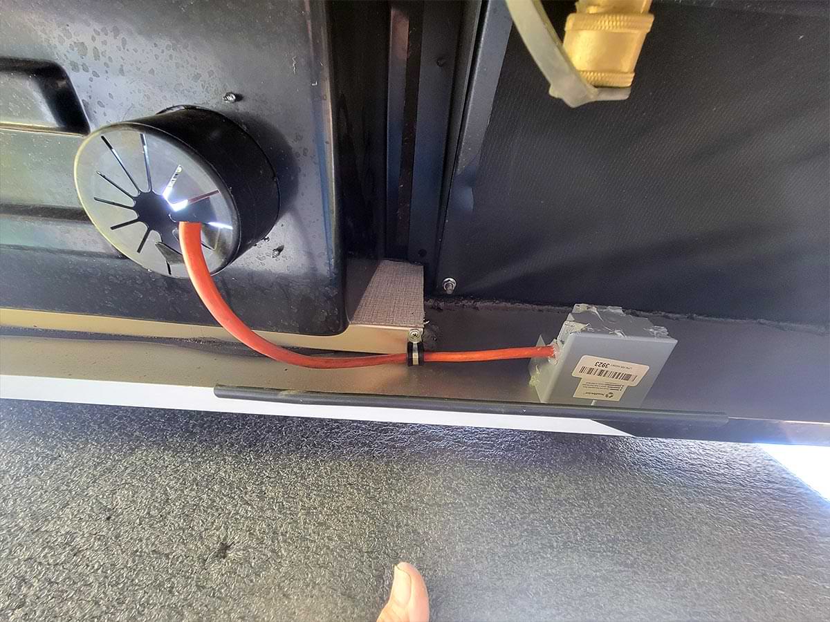 under side view of the RV showing the connection between the newly installed junction box and the cable hatch in the compartment floor