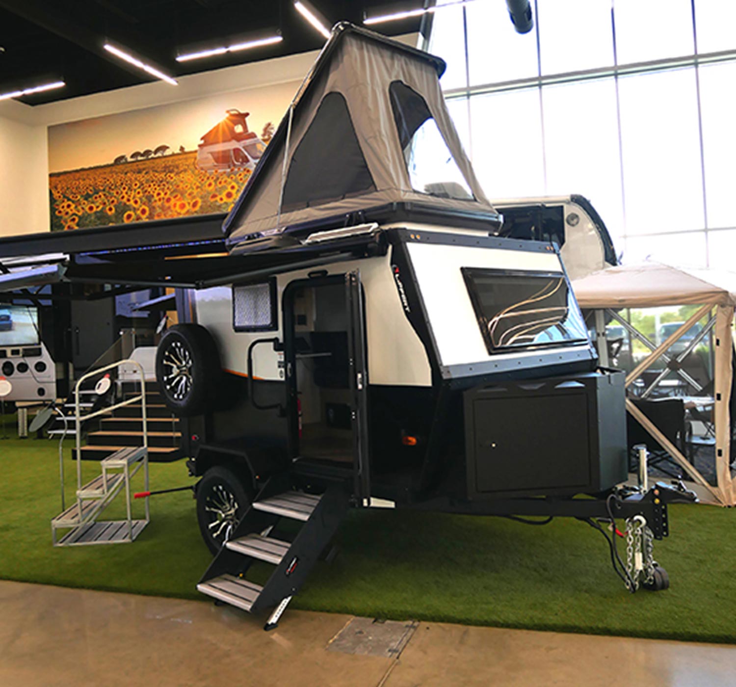 the Lippert pop top demonstrated on an Ember RV travel trailer at Lippert’s product showcase