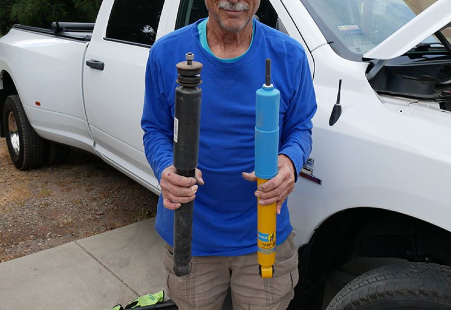 man holding stock shock absorbers