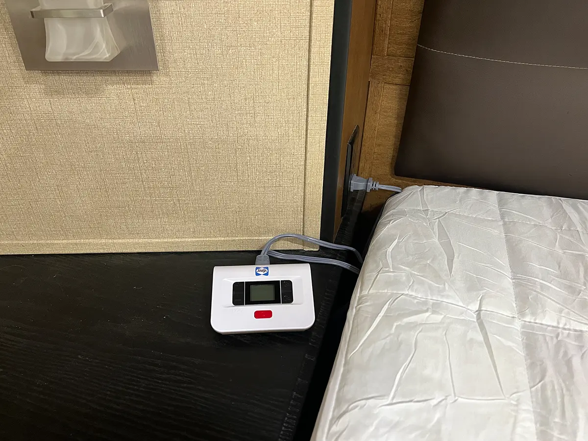 close view of one of the Sealy controllers on a night stand to the right of the bed