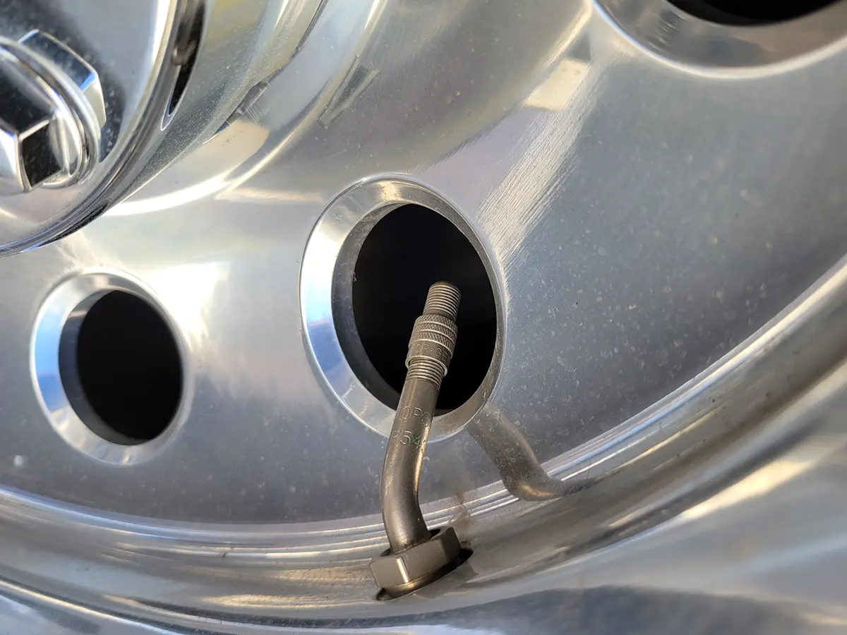 close view of a Gator Cap attached to an outside wheel on a dually truck