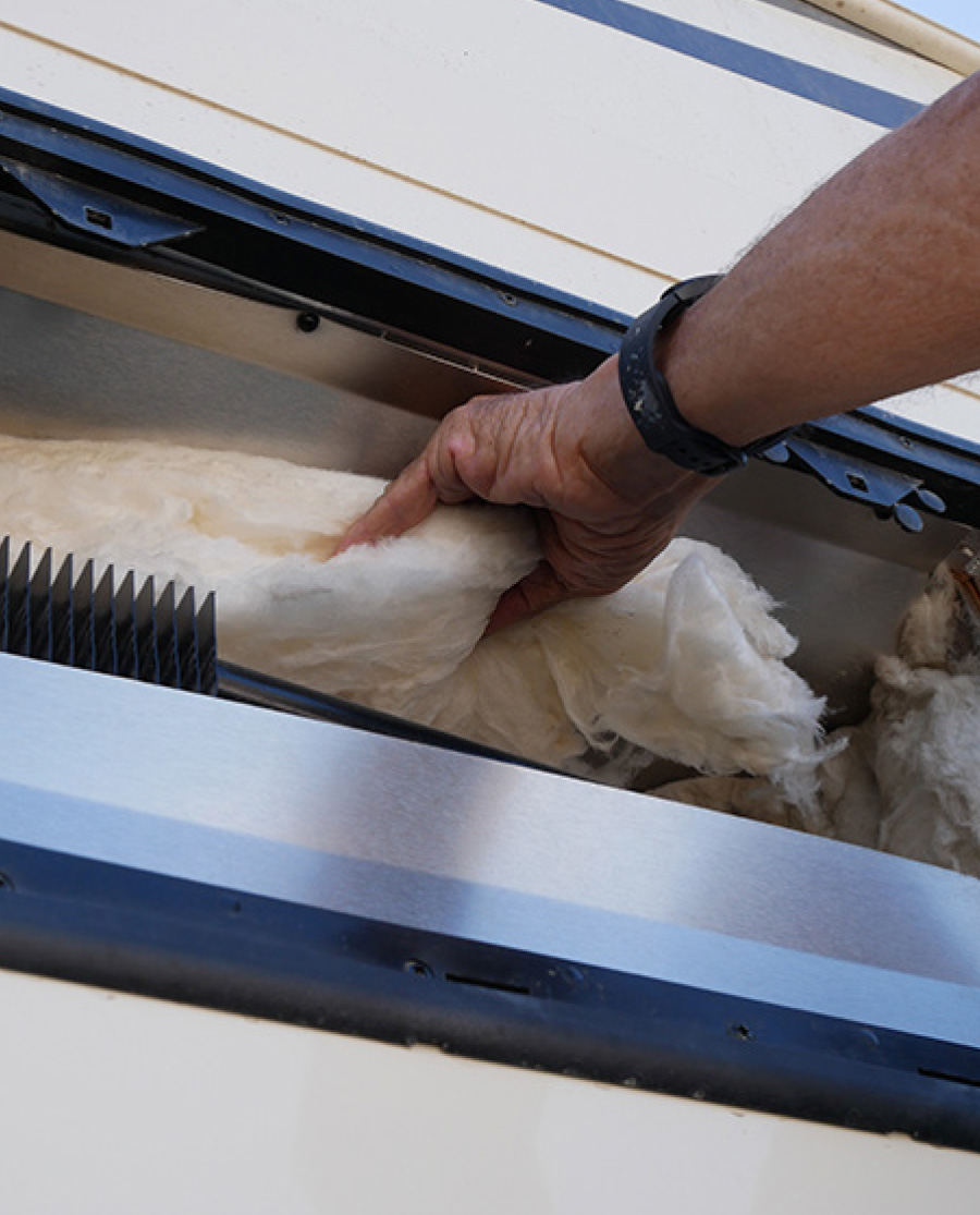 fiberglass insulation between at the top of the refrigerator and cabinet