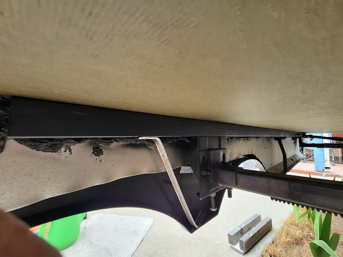 interior view of the RV undercarriage showing new brackets added to the fender skirt