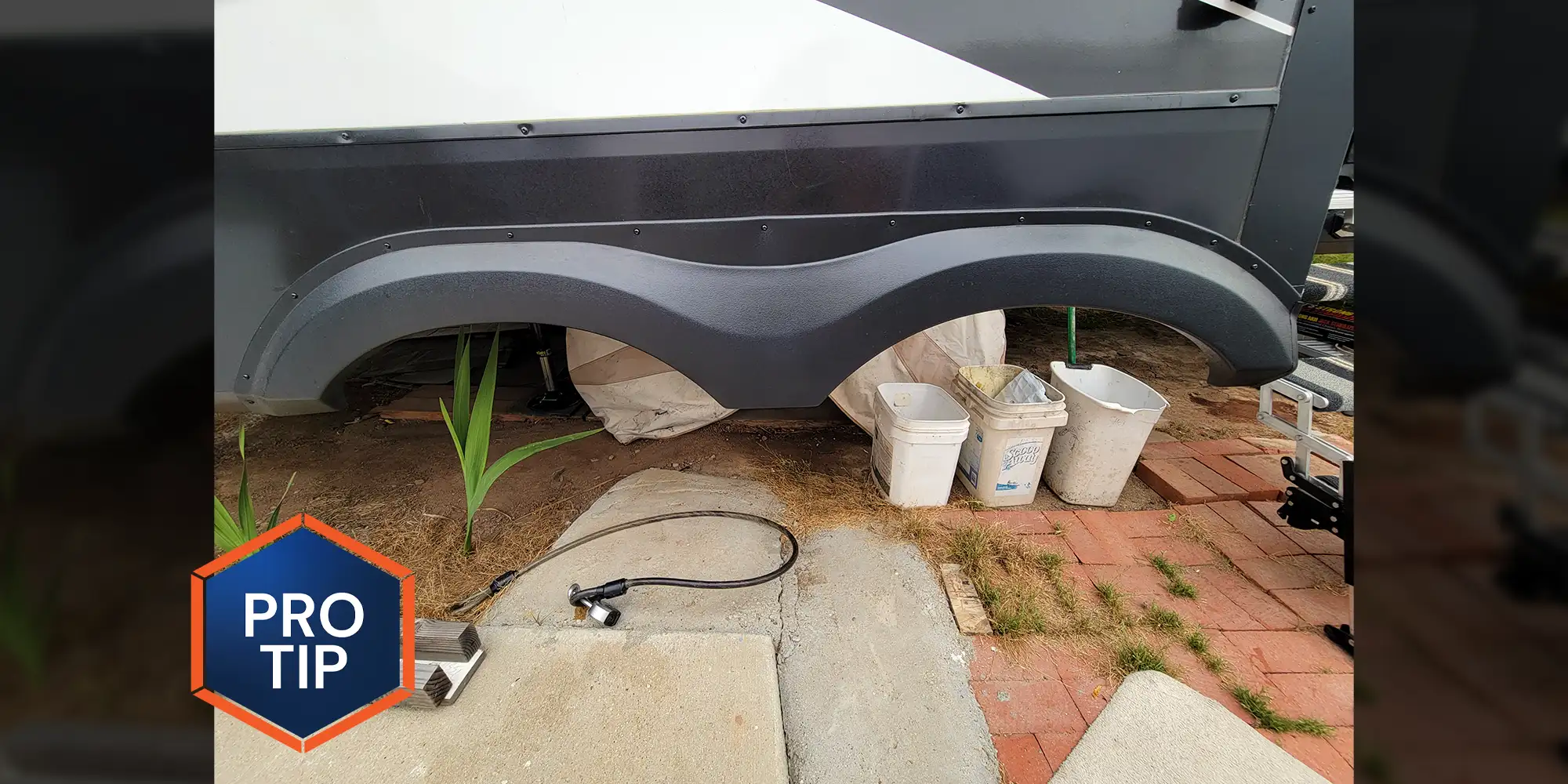 full view of the rear fender skirt on an RV with its tires removed