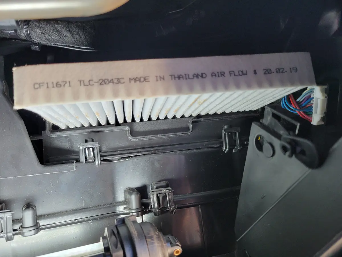 an air filter sticks out from the cabin air filter box