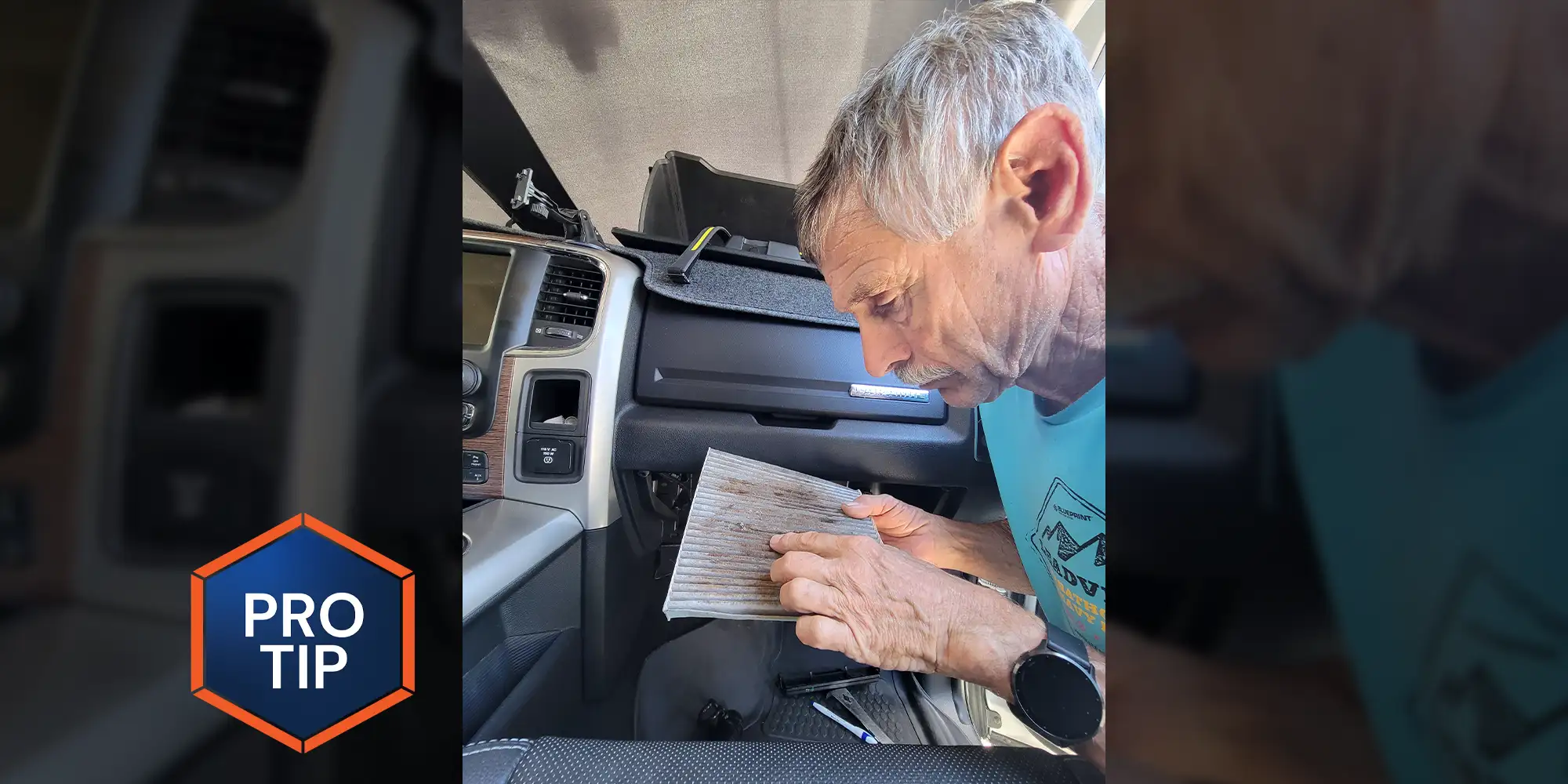 a man leaning into the passenger door of a truck looks closely at an old cabin air filter just removed