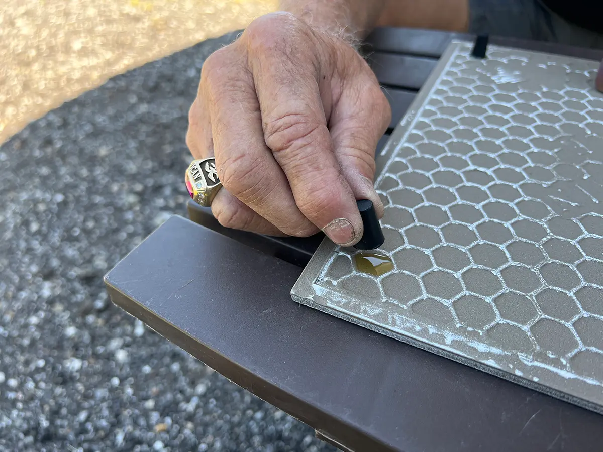 a hand holding a rubber stopper moves to place the stopper on the Gorilla Glue