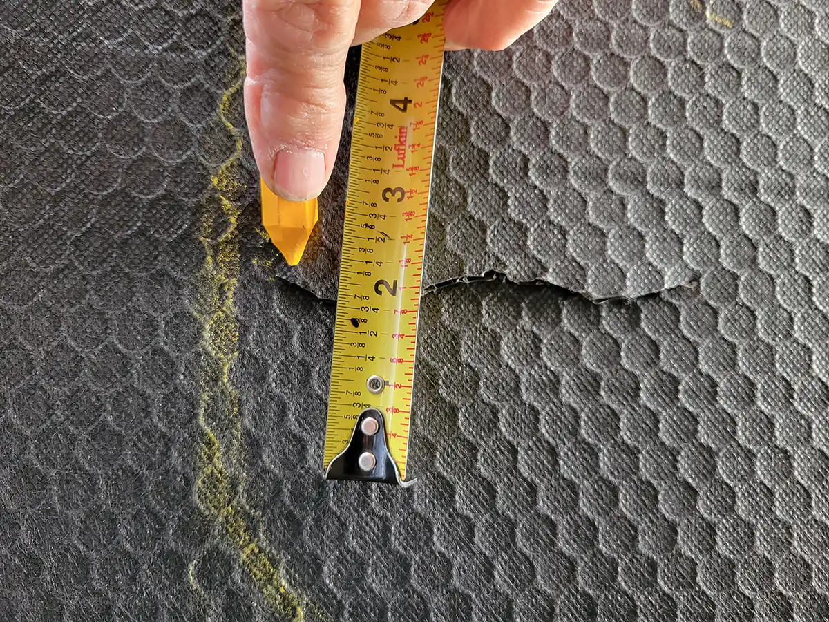 a tape measure and a yellow construction crayon are used to locate and mark the holes 1/2 inch from the cut on both sides