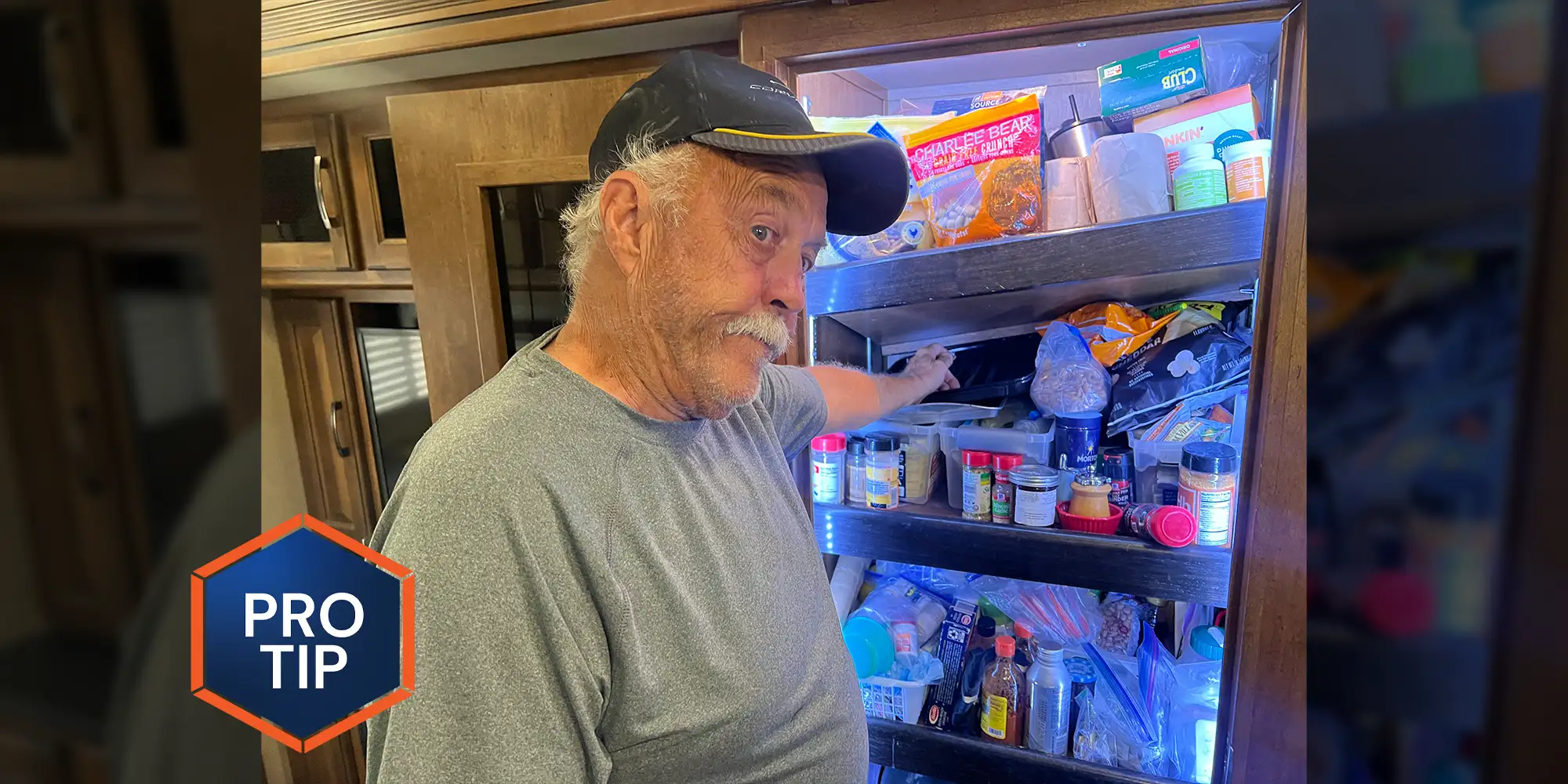 a man wears a frustrated look on his face while standing at a pantry with a fallen top shelf