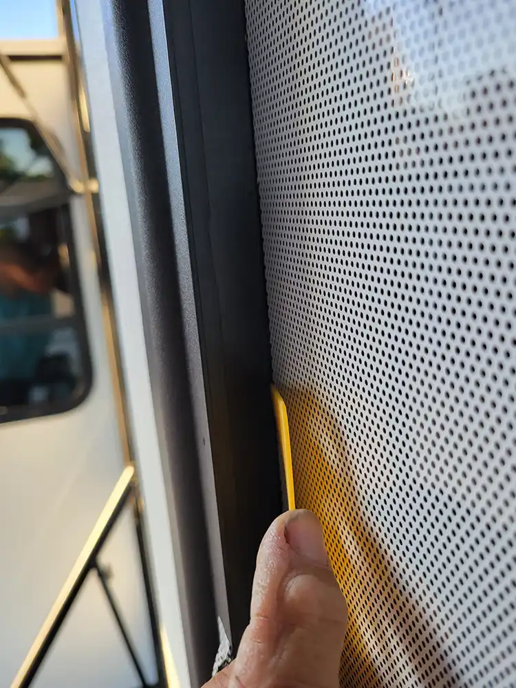 the squeegee pushes down the vinyl into the frame channel