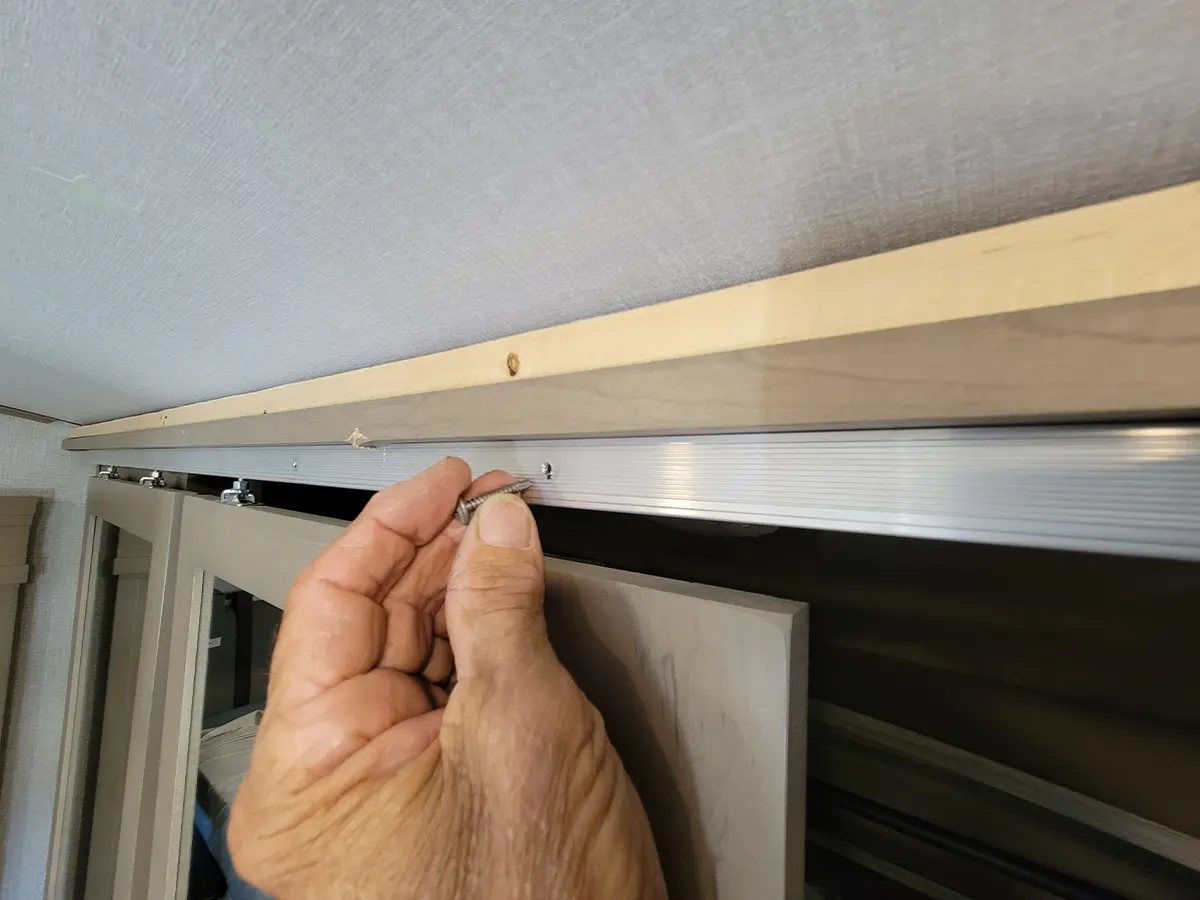 two stop screws are removed to allow the sliding doors to open further and make it possible to remove and replace the door guides and barn door rollers